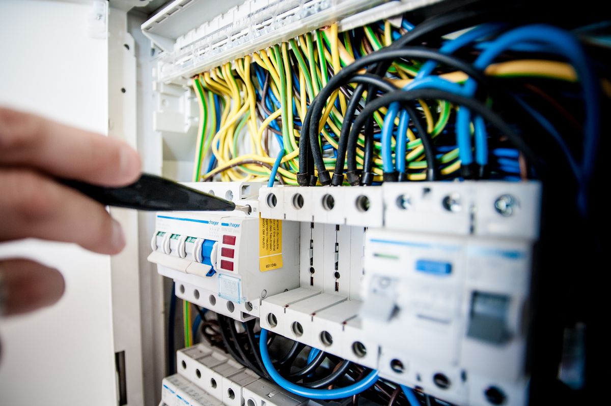 Contractor Insurance Michigan Michigan electrician working on an electrical panel