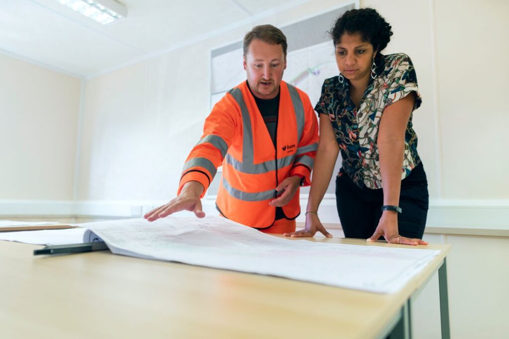 General contractor reviewing blueprints on site