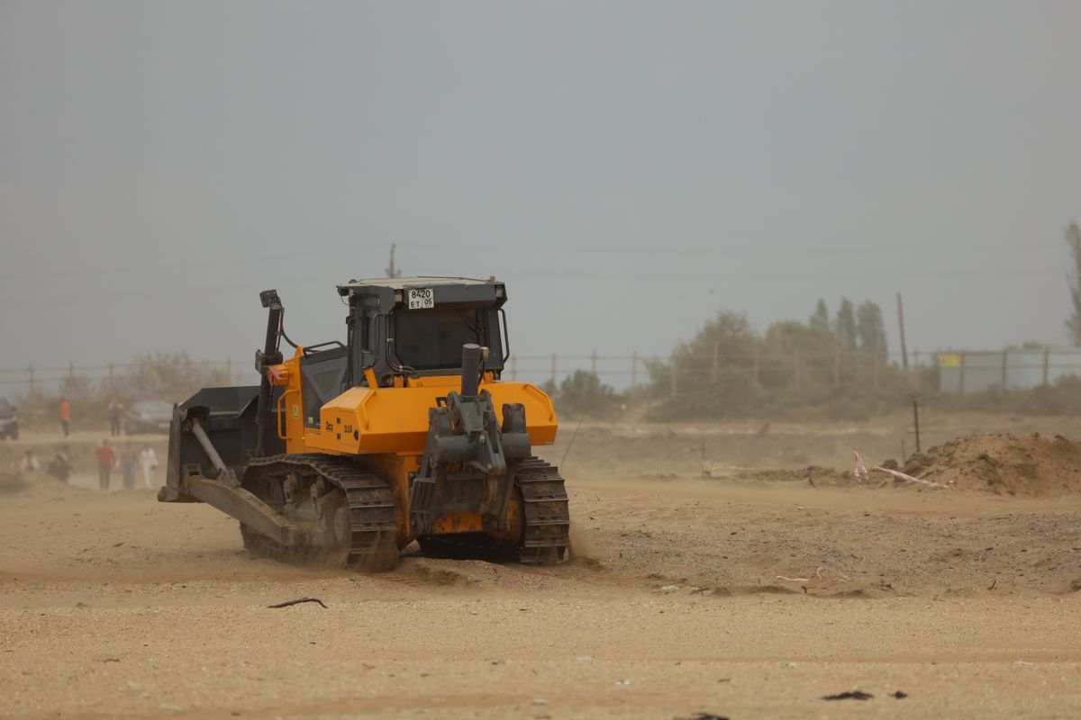 Pollution Liability Bulldozer working on a dusty earthwork site