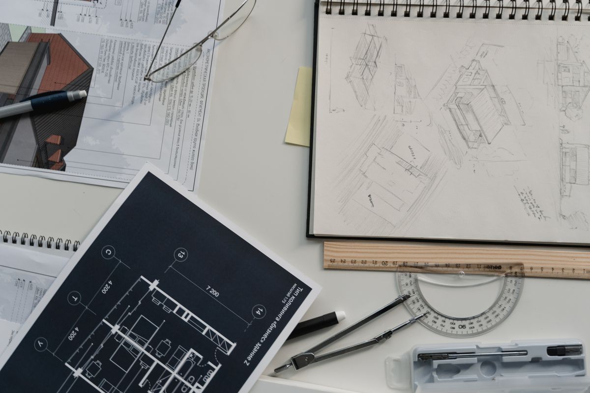 Professional Liability Architectural plans and drafting tools on a desk